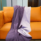 Ahinahwap waterproof blanket on a bed in deep purple guards against spills.