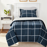 Amazon Basics 5-piece twin bedding set in navy and grey plaid for a coordinated bedroom look.