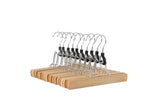 Amazon Basics wooden pants hangers in natural finish keep trousers neatly organized.
