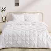 Amazon Basics pinch-pleat king comforter in bright white for a clean bedroom look.