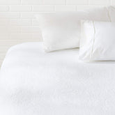 Amazon Basics waterproof mattress protector for king beds blocks spills while staying breathable.