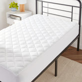 Amazon Basics hypoallergenic quilted topper pad on twin bed for added comfort
