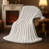 AmΓ©lie Home faux fur throw blanket on ivory couch for cozy evenings.