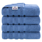 American Soft Linen electric blue 4-piece set on a rack, showcasing large 27x54 towels.