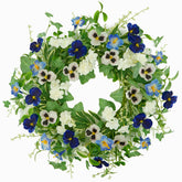 AMF0RESJ wreath on a front door with pansy blooms for a welcoming spring look.