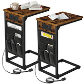 AMHANCIBLE C-shaped end table with USB charging ports beside a sofa for easy charging.