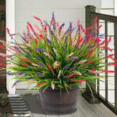 Ammyoo artificial monkey grass pack on porch for vibrant, UV-resistant outdoor decor.