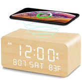 Andoolex wooden digital alarm clock with wireless charging on a nightstand, clutter-free charging.
