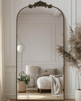 Antok arched mirror with bronze carved frame for full-body outfit checks.