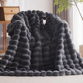 Anysay heated blanket throw on couch delivers instant warmth for cozy evenings.
