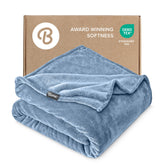Bare Home Coronet Blue blanket laid on bed for cozy warmth