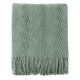 Battilo Home sage green throw on sofa highlights cozy texture for everyday lounging.