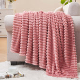 BEDELITE fleece blanket pink folded on couch showing cozy warmth and texture