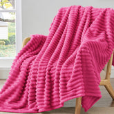 BEDELITE fleece throw blanket on couch in pink, cozy warmth for relaxing evenings.