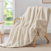 BEDELITE fleece throw blanket with striped pattern offering cozy warmth on the couch