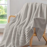 BEDELITE striped blanket on couch adds decorative warmth and texture.