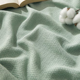 Bedsure GentleSoft cotton throw in sage green for couch warmth and breathable comfort.