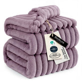 Bedsure GentleSoft light purple fleece blanket on sofa for cozy lounging.
