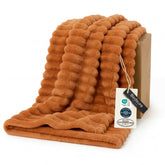 Bedsure GentleSoft orange fall throw on couch for cozy movie nights.