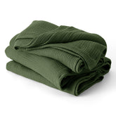 Bedsure muslin blanket in olive green on bed, breathable and lightweight for summer comfort.