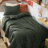 Bedsure Twin XL dark green comforter set on a dorm bed for all-season coziness.