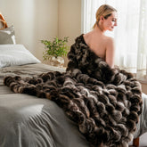 BENVWE Fluffy Faux Fur Throw Blanket on coffee bubble front for cozy lounging