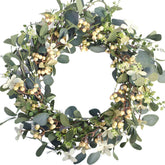 Bibelot 20-inch eucalyptus berry wreath on front door for seasonal charm.