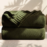blunique olive-green cotton cable knit throw on sofa for versatile lounging