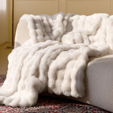Blunique ultra-soft-faux-fur throw blanket in cream provides plush couch warmth.