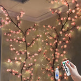 BomKra cherry LED tree branch lights on wall create a soft pink glow.