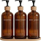Brighter Barns amber dispenser bottles show eco-friendly, refillable bathroom storage.