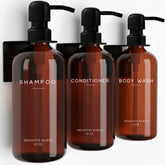 Brighter Barns amber shampoo dispenser wall-mount for organized shower storage.