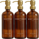 Brighter Barns luxury dispenser with amber bottle and gold pump for elegant bathroom decor.