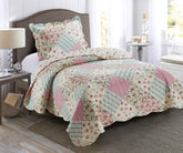 Brilliant Sunshine pink-green patchwork quilt set front view on a twin bed for cozy styling.