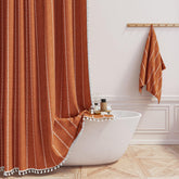 BTTN boho farmhouse shower curtain tassel detail enhances bathroom decor.