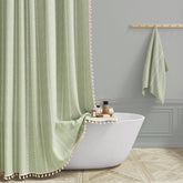 BTTN sage green farmhouse shower curtain with tassel trim enhances luxurious boho bathroom ambiance.