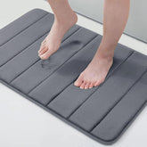 Buganda memory foam bath mat with plush velvet surface for soft, cushiony feet.