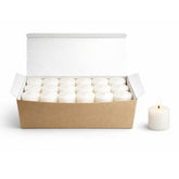 Candlestock white votive candles in a box provide long-lasting, reliable light for events.