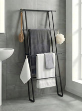 CANYAVE metal leaning ladder towel rack assembled against wall saves space for towels.