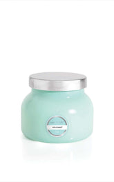 Capri Blue Volcano Aqua petite jar candle enhances living room ambiance with tropical citrus.