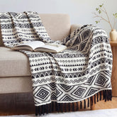 CASAAGUSTO boho throw blanket on a couch; tassels add texture and style.
