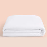 Casper mattress protector on queen bed, top view, keeps mattress dry and breathable