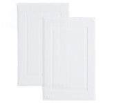 Casual Living white cotton bath mat 34x21 inches near shower for soft, absorbent comfort.