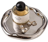 CHENDECOR silver round vanity tray with grooved edges for secure jewelry storage.
