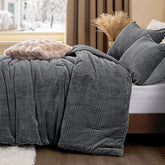 ChiXpace flannel fleece queen comforter set on bed with plush leaves pattern for cozy warmth.