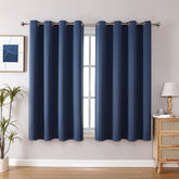 ChrisDowa grommet blackout curtains in stone blue for a two-panel bedroom setup.
