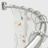 Chrsouly curved shower rod extended for extra shower space.