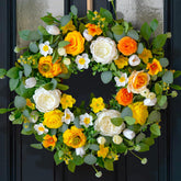 CHvista 24-inch spring wreath with yellow and white blooms brightening the entry.