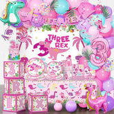 Cocomigo Three Rex banner enhances the pink dinosaur party backdrop for photos.