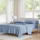 Comfort Spaces blue flat sheet on bed, smooth and breathable for all-season comfort.